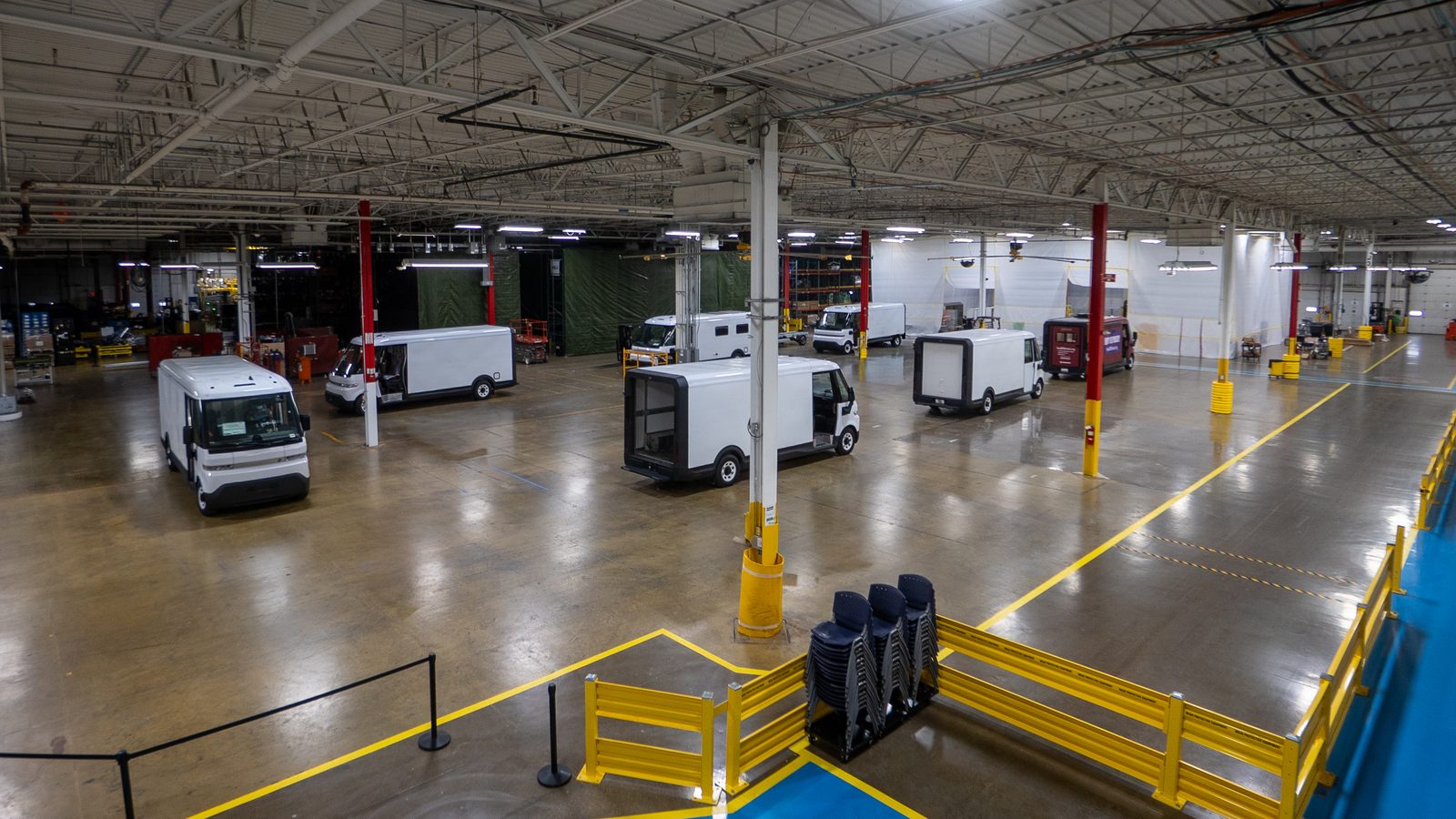 Grounded's 50,000 sq ft manufacturing facility in Detroit, with electric vans on the production floor